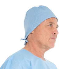 Man wearing light blue disposable surgical cap and gown for medical use