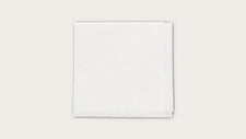 Sterile white medical gauze pad on a plain background