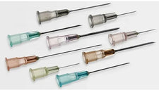 Assorted sterile hypodermic needles with colored hubs for medical use on white background