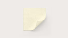 Beige medical gauze pad on white background with corner folded