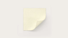 Sterile medical adhesive dressing pad with one corner peeled on white background