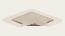 Sterile adhesive wound dressing with transparent border and absorbent pad on white background