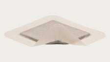 Sterile medical wound dressing with transparent adhesive border on white background